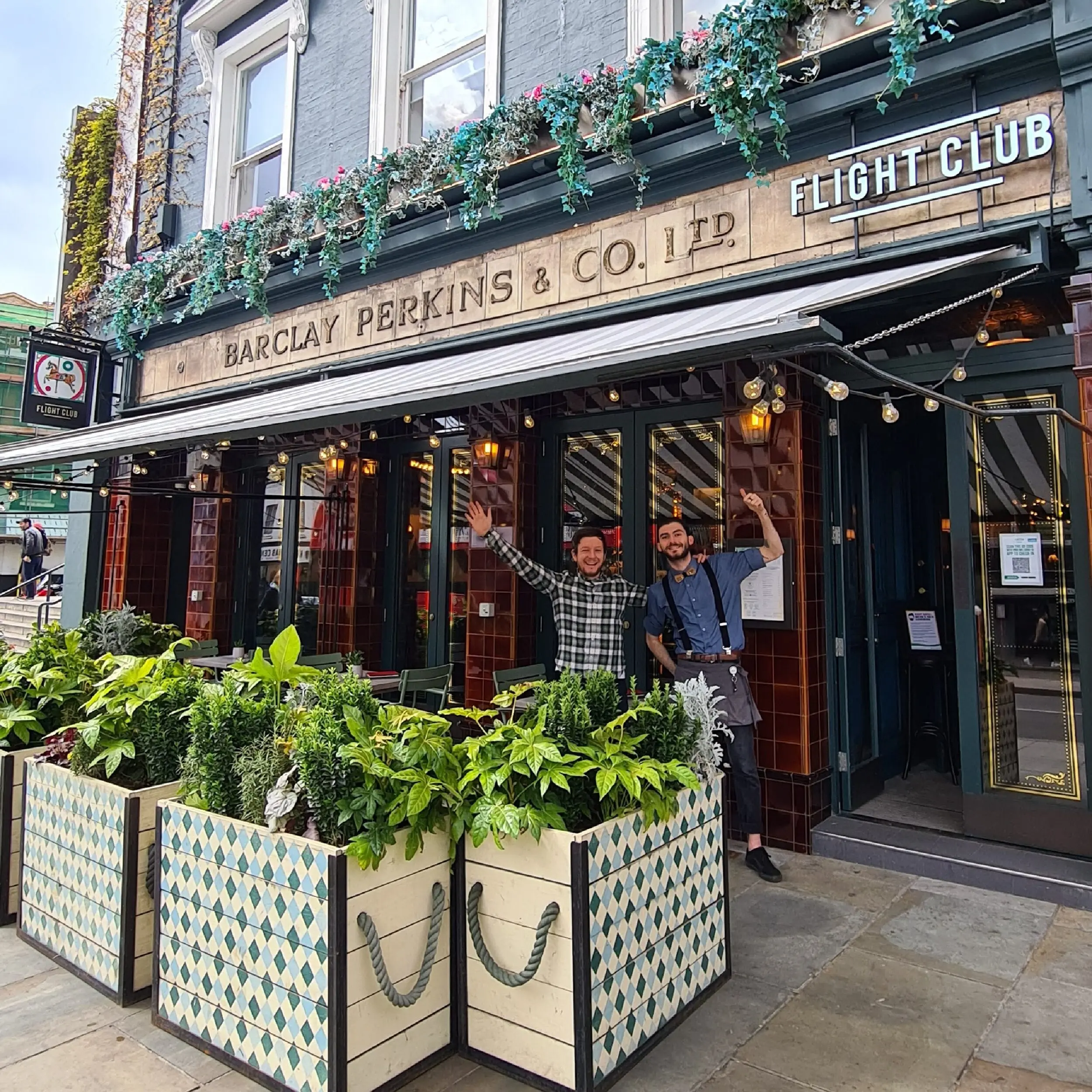 Flight Club - Baylis Industrial Cafe Planter Bespoke Commercial Outdoor Baylis Industrial Café Planters with Stencilled Harlequin Pattern & Green Twisted Barrier Ropes.