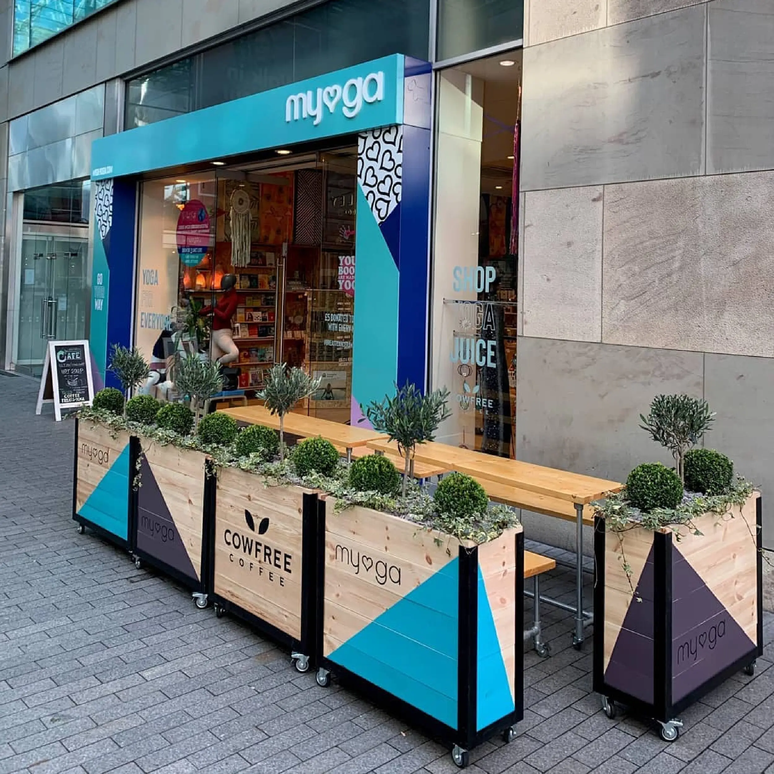 Myga - Baylis Industrial Cafe Planter Myga, Birmingham with Baylis Cafe Planters with Commercial Wooden Scaffold Furniture. Restaurant Planters UK Made & Bespoke.