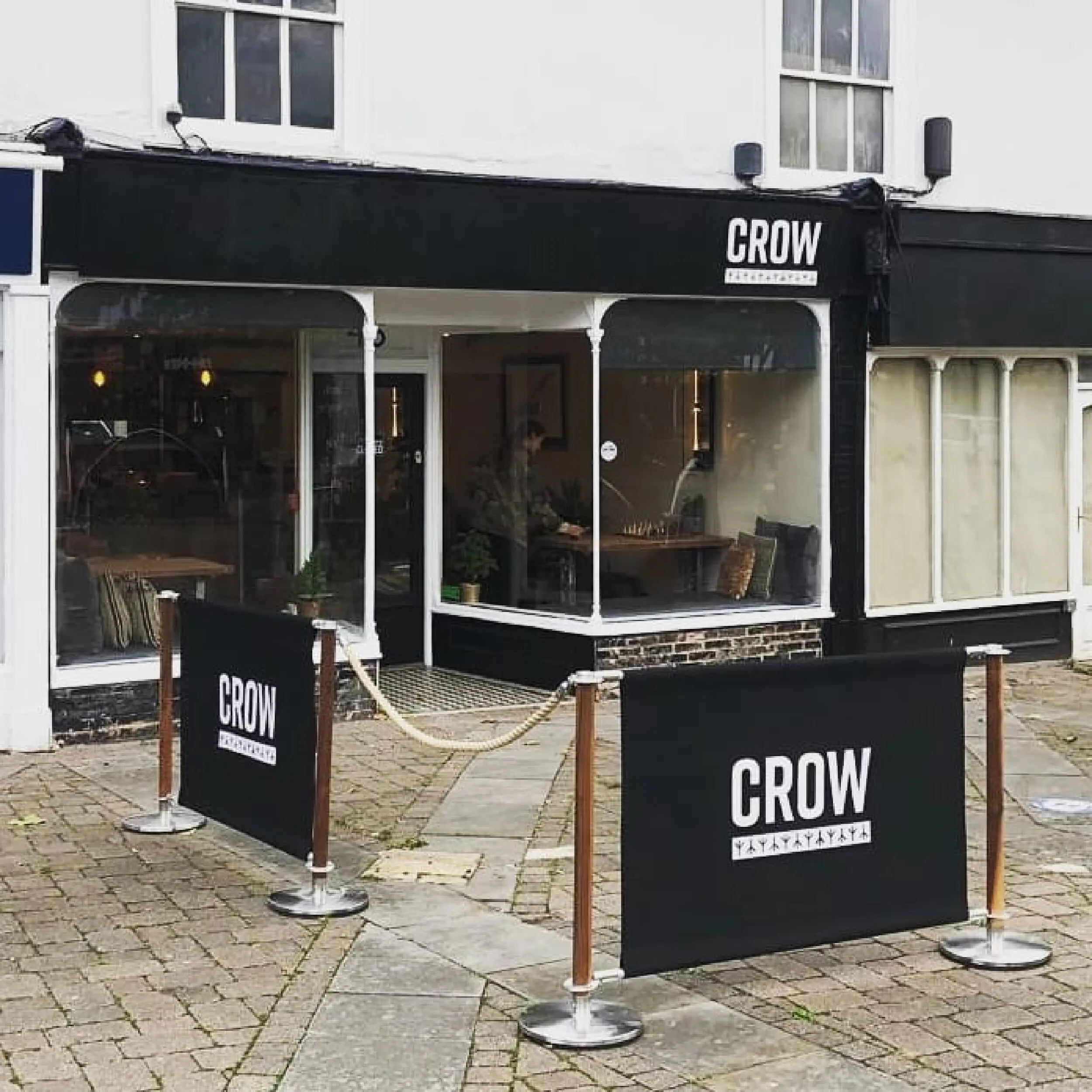 Natural Cafe Barrier Post & Canvas Cafe Banners - Crow Coffee Natural Rope & Post Stanchion with Black Canvas cafe Banners for Crow Coffee, printed café banners, bespoke café banners, handmade café banners, custom café banners, café screens, fabric café banners, walnut wooden cafe posts, handmade cafe barrier posts, bespoke cafe barrier posts