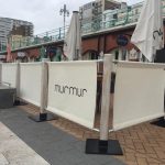 MurMur in Brighton with Lime Washed Rustic Cafe Barrier Posts and Cream Canvas Banners Finished off with Their Logo in Dark Grey