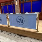 Manzi's Canvas Café Banners in Blue with Advance Café Barrier Post with Surface Mounted Bases