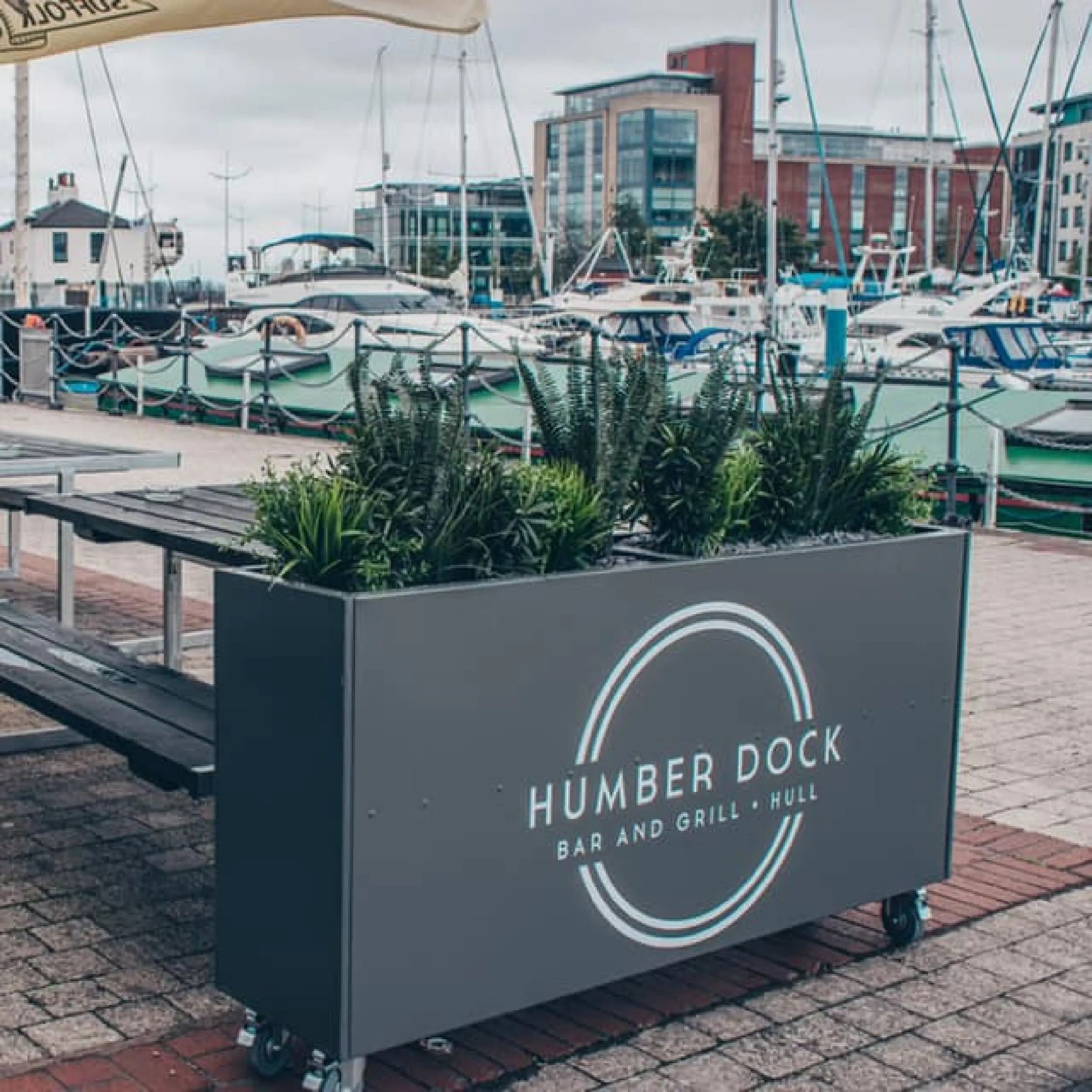 Humber Dock Bar & Grill - Forjado Powder Coated Café Planter Humber Dock in Hull Forjado Powder Coated Cafe Planters, Powder Coated in Grey, Commercial Planters, Heavy Duty Cafe Planters, Metal Planters, Bespoke Cafe Planters, Branded Cafe Planters, Custom Cafe Planters, Outdoor Cafe Planters, Pavement Planters