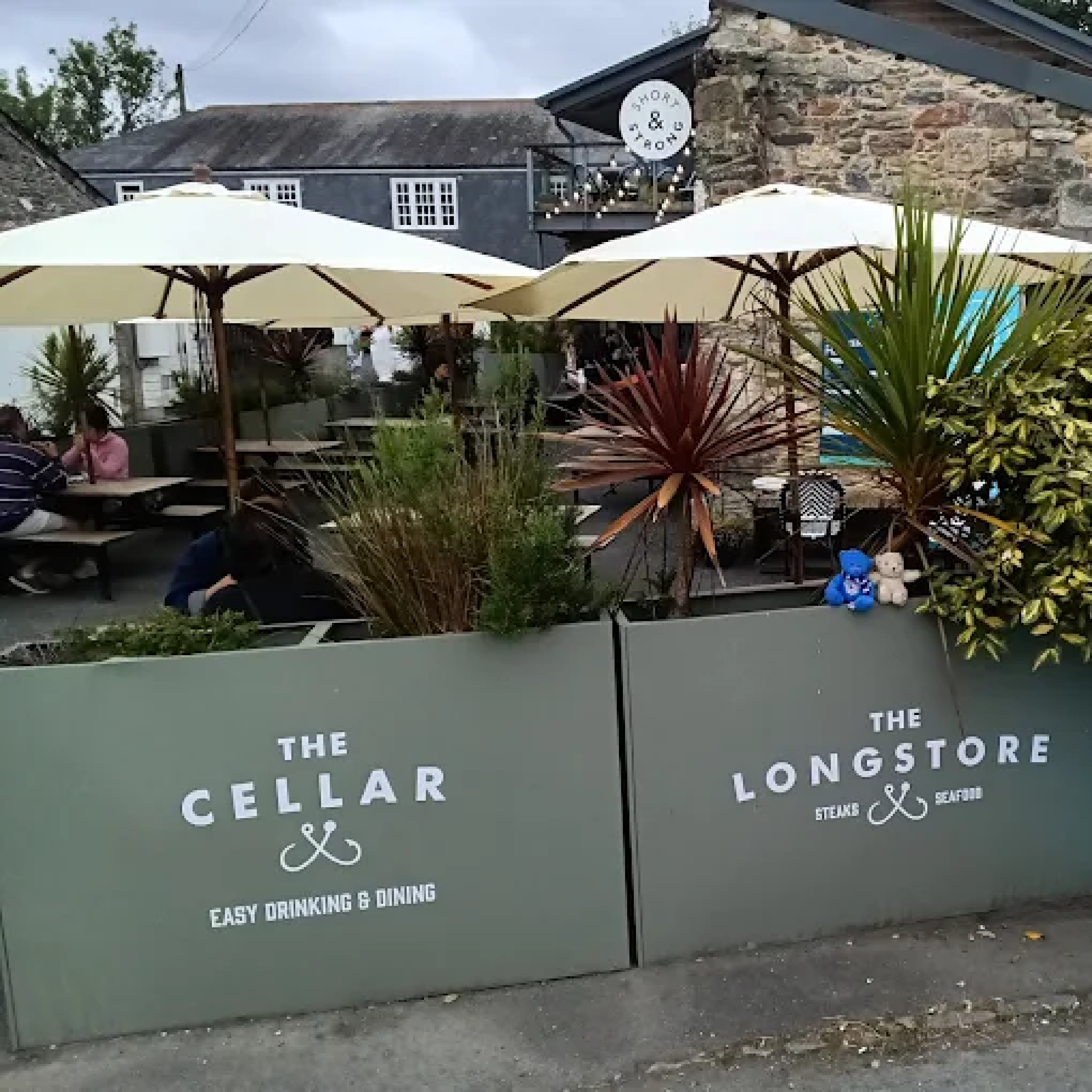The Longstore - Forjado Powder Coated Café Planter Longshore in Cornwall Forjado Metal Planters Powder Coated in Green with their logos to all, Commercial Planters, Heavy Duty Cafe Planters, Metal Planters, Bespoke Cafe Planters, Branded Cafe Planters, Custom Cafe Planters, Outdoor Cafe Planters, Pavement Planters