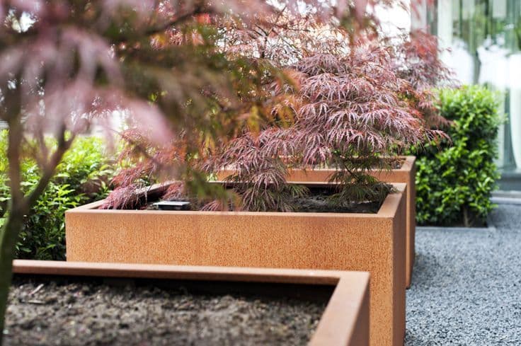 Corten Steel Square Planters With Wheels Close Up Planted