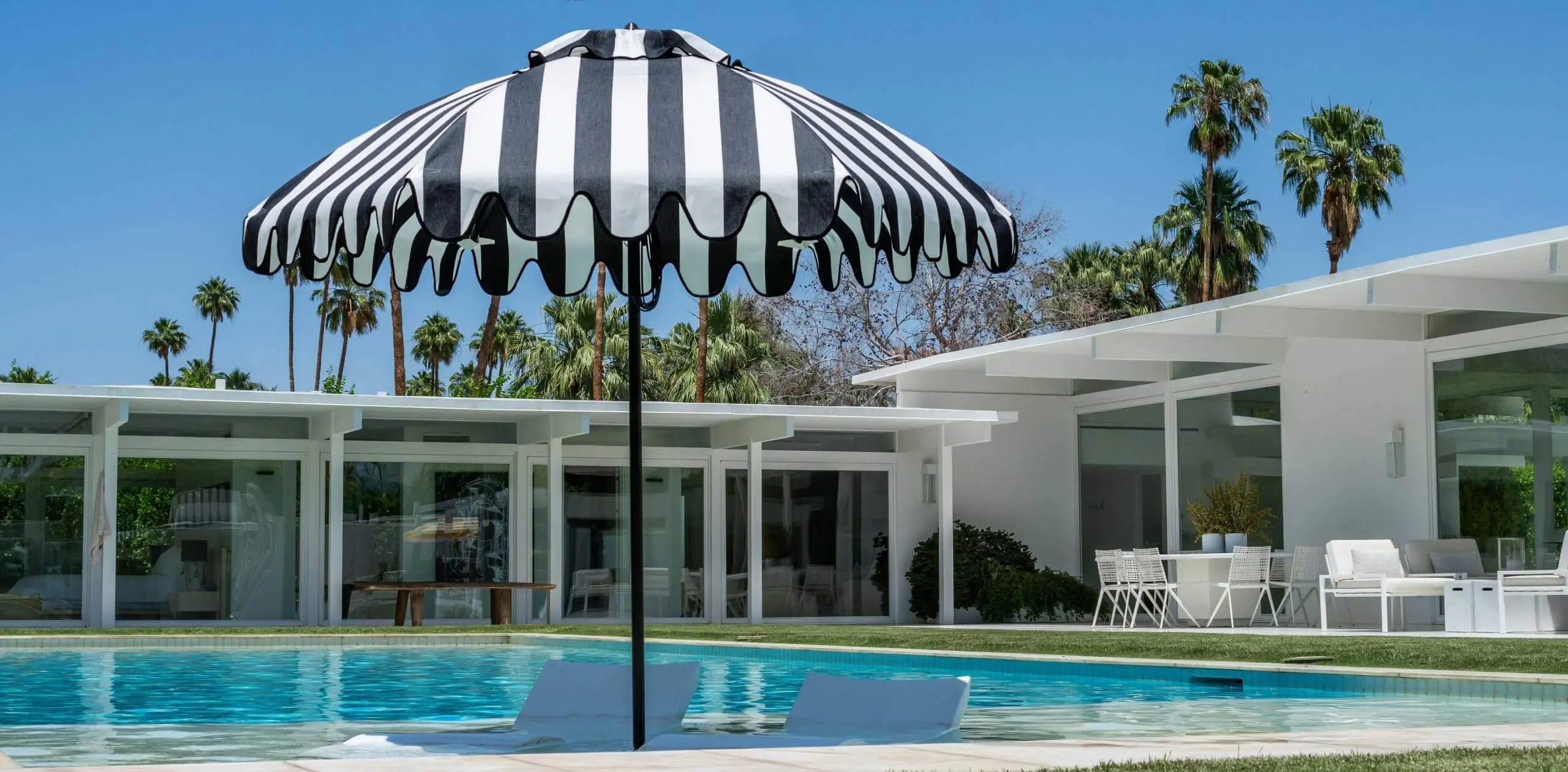 Black & White Stripe Mirasol with Marquis Fringe Giant Umbrella Santa Barbara Black & White Stripe Mirasol Giant Umbrella in Pool Setting with Marquis Fringe Optional Extra, Commercial Umbrellas, Commercial Giant Umbrellas, Restaurant Parasols, Hospitality Giant Umbrella, Pub Parasol