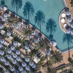 Tuuci M1 Cupola Giant Umbrella with Blue and White Stripes Ariel View Tuuci Hexagonal OceanMaster M1 Cupola Giant Umbrella in Blue and White Stripes around a Pool Ariel View, Giant Umbrellas, Commercial Giant Umbrellas, Hospitality Giant Umbrellas, Parasols, Restaurant Umbrellas, Outdoor Umbrellas, Fabric Umbrellas, Giant Umbrellas with Logos, Tuuci Umbrellas, Tuuci Giant Umbrellas