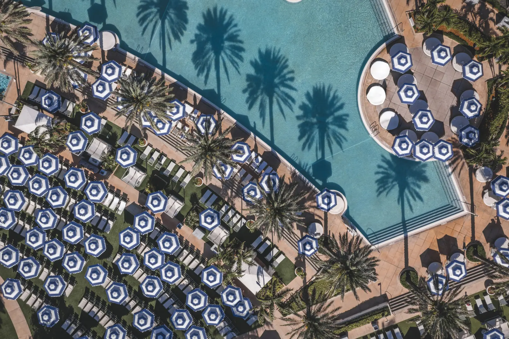 Tuuci M1 Cupola Giant Umbrella with Blue and White Stripes Ariel View Tuuci Hexagonal OceanMaster M1 Cupola Giant Umbrella in Blue and White Stripes around a Pool Ariel View, Giant Umbrellas, Commercial Giant Umbrellas, Hospitality Giant Umbrellas, Parasols, Restaurant Umbrellas, Outdoor Umbrellas, Fabric Umbrellas, Giant Umbrellas with Logos, Tuuci Umbrellas, Tuuci Giant Umbrellas