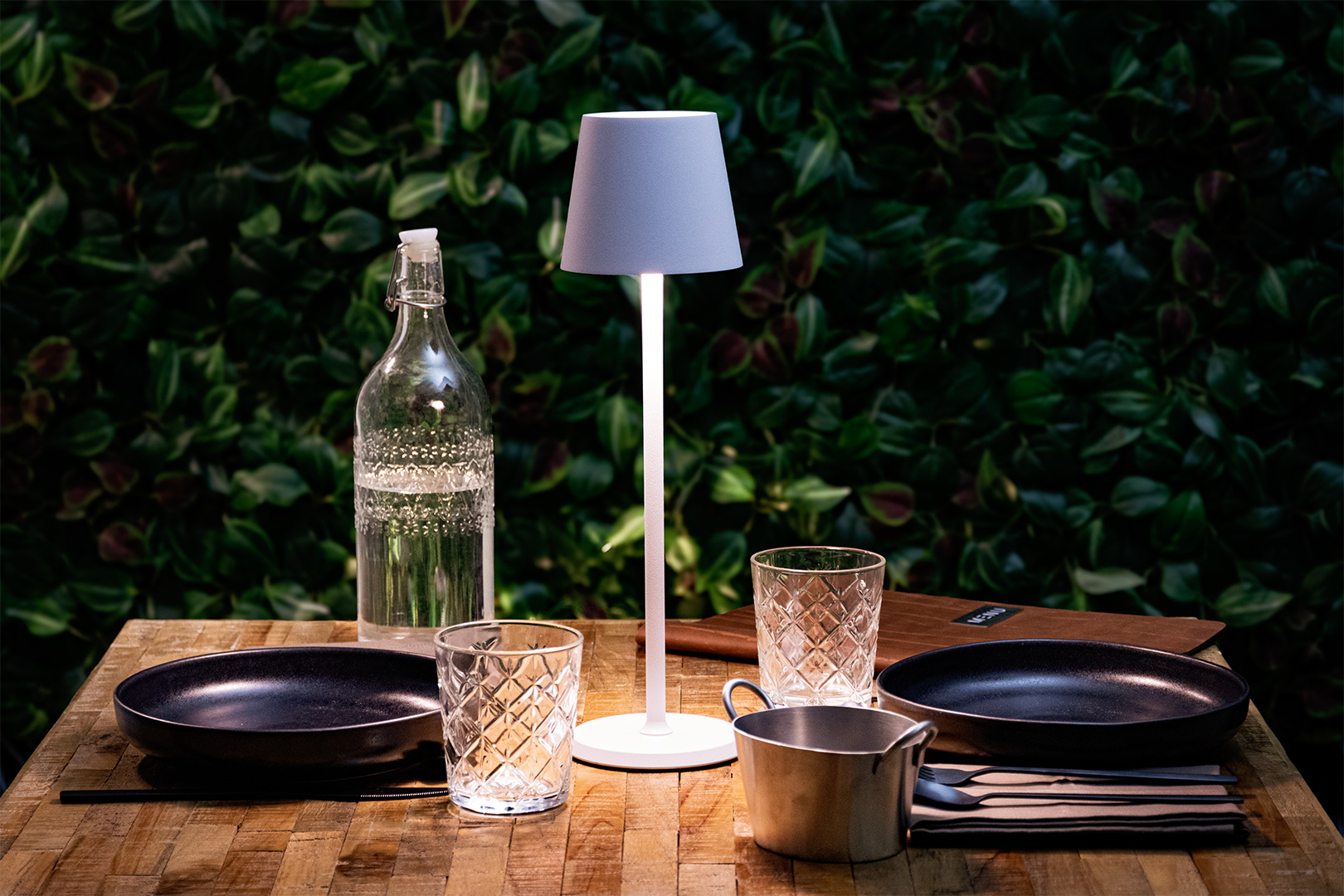 Felis LED Rechargeable Table Lamp in White on a Wooden Table Outside Felis LED Rechargeable Table Lamp in White on a Wooden Table Outside, Table Lighting, Restaurant Lighting, Lighting for Table at Restaurant, Commercial Table Lighting, Hospitality Lighting, Rechargeable Table Lamps, LED Lighting, Outdoor Table Lamps, Indoor Table Lighting, Cafe Lighting, Table Lamps for Cafes