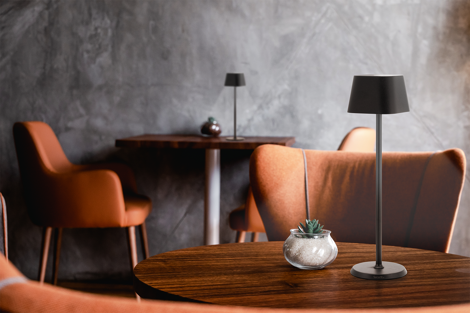 Gigi LED Rechargeable Table Lamp in Black Gigi LED Rechargeable Table Lamp in Black on a Wooden Table Inside, Table Lighting, Restaurant Lighting, Lighting for Table at Restaurant, Commercial Table Lighting, Hospitality Lighting, Rechargeable Table Lamps, LED Lighting, Outdoor Table Lamps, Indoor Table Lighting, Cafe Lighting, Table Lamps for Cafes