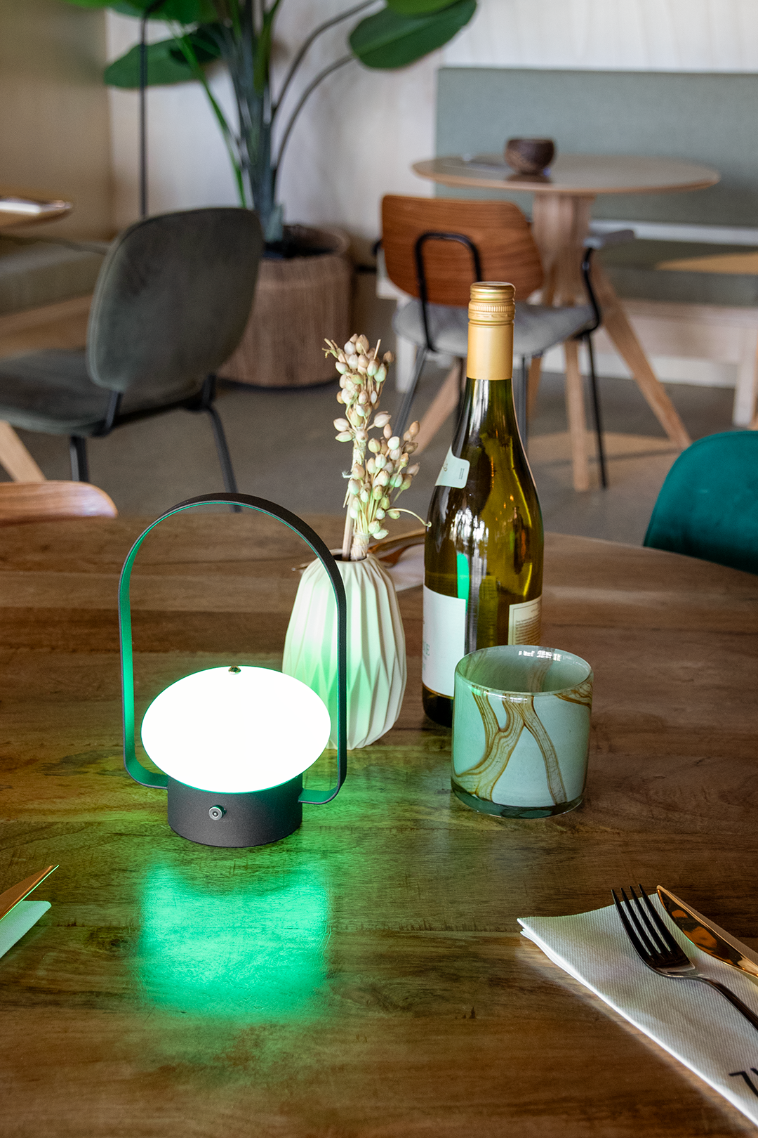 Badalona Rechargeable Table Lamp on a Wooden Table Inside a Restaurant Lit Up Green Badalona Rechargeable Table Lamp on a Wooden Table Inside a Restaurant Lit Up Green, Service Table Lamp, Table Lighting, Restaurant Lighting, Lighting for Table at Restaurant, Commercial Table Lighting, Hospitality Lighting, Rechargeable Table Lamps, LED Lighting, Outdoor Table Lamps, Indoor Table Lighting, Cafe Lighting, Table Lamps for Cafes