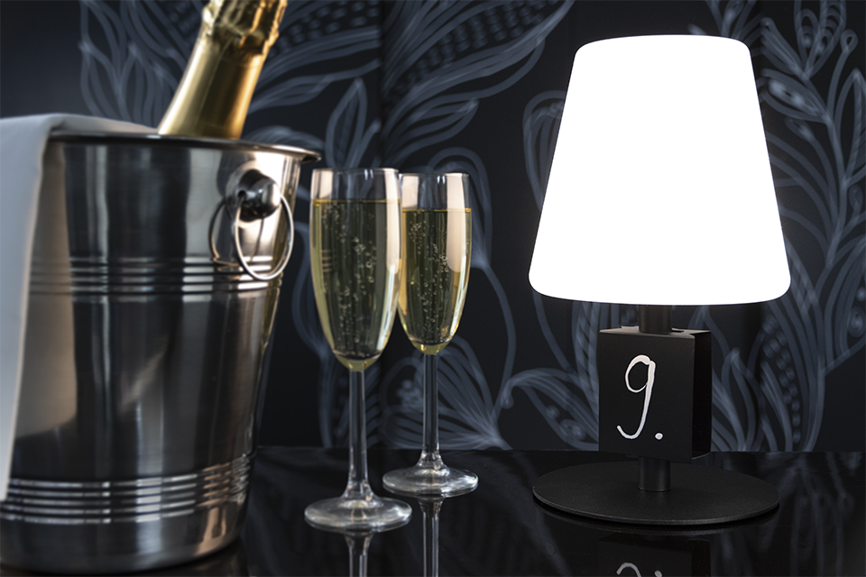 Michel Rechargeable Table Lamp in Black with Mini Chalkboard next to Champagne and Glasses Michel Rechargeable Table Lamp in Black with Mini Chalkboard next to Champagne and Glasses, Table Lighting, Restaurant Lighting, Lighting for Table at Restaurant, Commercial Table Lighting, Hospitality Lighting, Rechargeable Table Lamps, LED Lighting, Outdoor Table Lamps, Indoor Table Lighting, Cafe Lighting, Table Lamps for Cafes, Vase Table Lamp, Table Lamp for Flowers