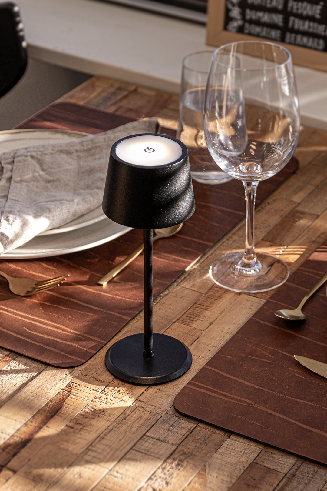 Monaco Rechargeable Table Lamp in Black on a Wooden Table Inside a Restaurant in the Sunshine Monaco Rechargeable Table Lamp in Black on a Wooden Table Inside a Restaurant in the Sunshine, Table Lighting, Restaurant Lighting, Lighting for Table at Restaurant, Commercial Table Lighting, Hospitality Lighting, Rechargeable Table Lamps, LED Lighting, Outdoor Table Lamps, Indoor Table Lighting, Cafe Lighting, Table Lamps for Cafes