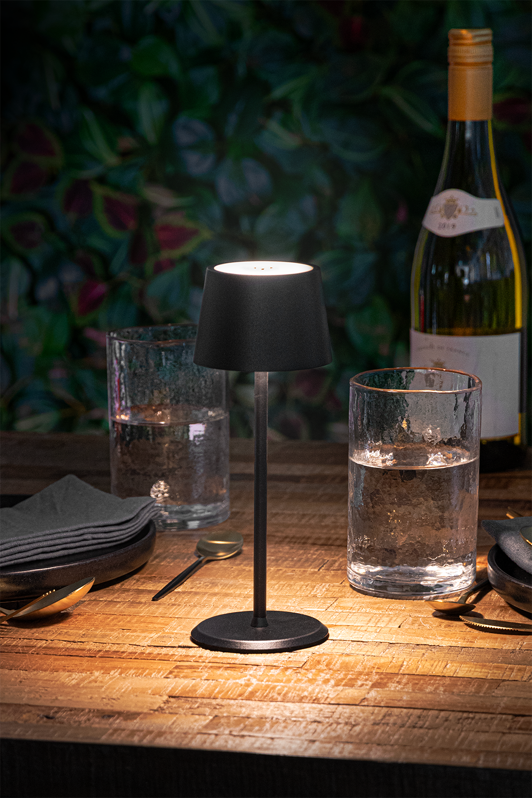 Monaco Rechargeable Table Lamp in Black on a Wooden Table Outside a Restaurant in the Night-Time Monaco Rechargeable Table Lamp in Black on a Wooden Table Outside a Restaurant in the Night-Time, Table Lighting, Restaurant Lighting, Lighting for Table at Restaurant, Commercial Table Lighting, Hospitality Lighting, Rechargeable Table Lamps, LED Lighting, Outdoor Table Lamps, Indoor Table Lighting, Cafe Lighting, Table Lamps for Cafes