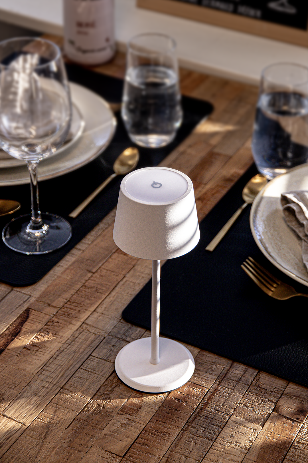 Monaco Rechargeable Table Lamp in White on a Wooden Table Inside a Restaurant in the Sunshine Monaco Rechargeable Table Lamp in White on a Wooden Table Inside a Restaurant in the Sunshine, Table Lighting, Restaurant Lighting, Lighting for Table at Restaurant, Commercial Table Lighting, Hospitality Lighting, Rechargeable Table Lamps, LED Lighting, Outdoor Table Lamps, Indoor Table Lighting, Cafe Lighting, Table Lamps for Cafes