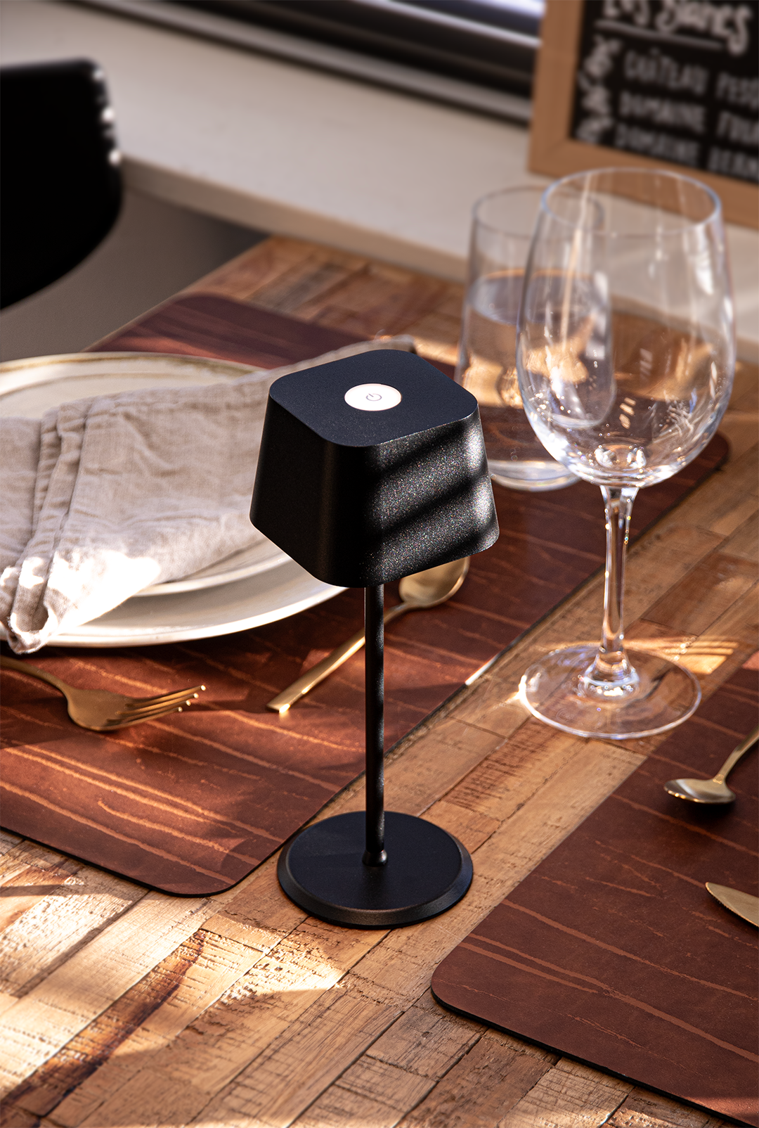 Valletta Rechargeable Table Lamp in Black on a Wooden Table Inside a Restaurant Valletta Rechargeable Table Lamp in Black on a Wooden Table Inside a Restaurant, Table Lighting, Restaurant Lighting, Lighting for Table at Restaurant, Commercial Table Lighting, Hospitality Lighting, Rechargeable Table Lamps, LED Lighting, Outdoor Table Lamps, Indoor Table Lighting, Cafe Lighting, Table Lamps for Cafes