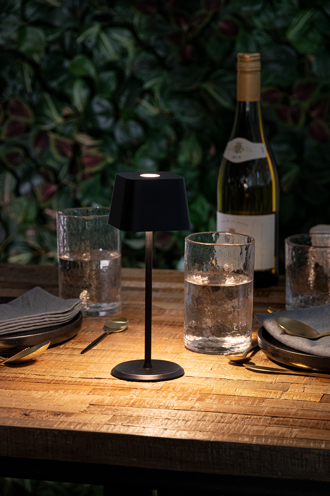 Valletta Rechargeable Table Lamp in Black on a Wooden Table Outside a Restaurant at Night-Time Valletta Rechargeable Table Lamp in Black on a Wooden Table Outside a Restaurant at Night-Time, Table Lighting, Restaurant Lighting, Lighting for Table at Restaurant, Commercial Table Lighting, Hospitality Lighting, Rechargeable Table Lamps, LED Lighting, Outdoor Table Lamps, Indoor Table Lighting, Cafe Lighting, Table Lamps for Cafes