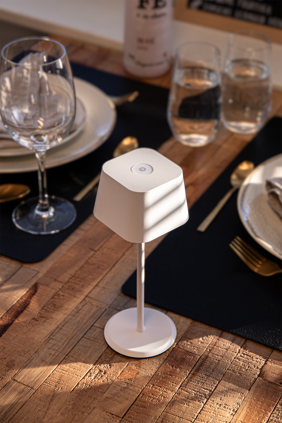 Valletta Rechargeable Table Lamp in White on a Wiiden Table in a Restaurant Valletta Rechargeable Table Lamp in White on a Wooden Table in a Restaurant, Table Lighting, Restaurant Lighting, Lighting for Table at Restaurant, Commercial Table Lighting, Hospitality Lighting, Rechargeable Table Lamps, LED Lighting, Outdoor Table Lamps, Indoor Table Lighting, Cafe Lighting, Table Lamps for Cafes