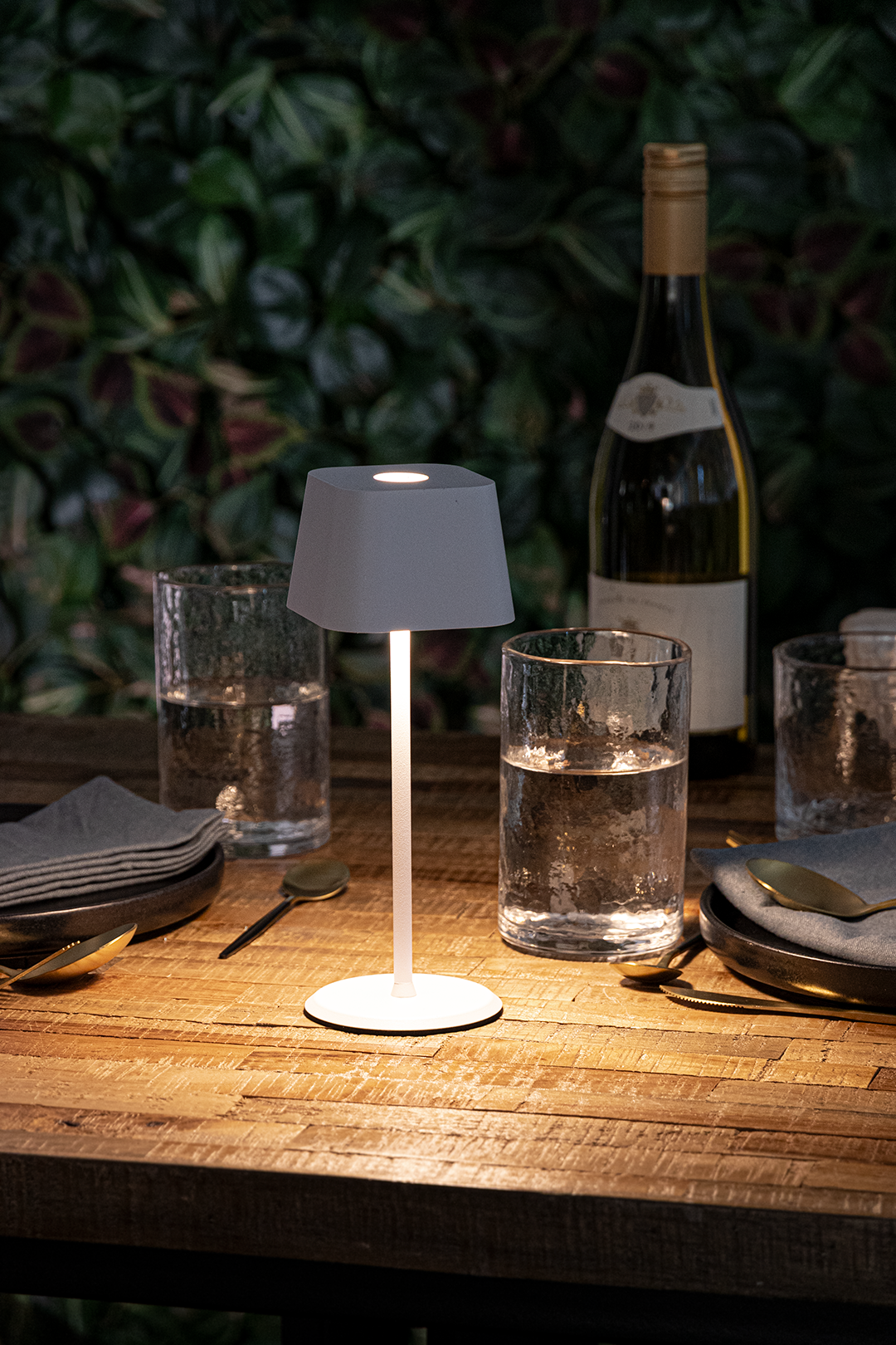 Valletta Rechargeable Table Lamp in White on a Wooden Table Outside a Restaurant at Night-Time Valletta Rechargeable Table Lamp in White on a Wooden Table Outside a Restaurant at Night-Time, Table Lighting, Restaurant Lighting, Lighting for Table at Restaurant, Commercial Table Lighting, Hospitality Lighting, Rechargeable Table Lamps, LED Lighting, Outdoor Table Lamps, Indoor Table Lighting, Cafe Lighting, Table Lamps for Cafes