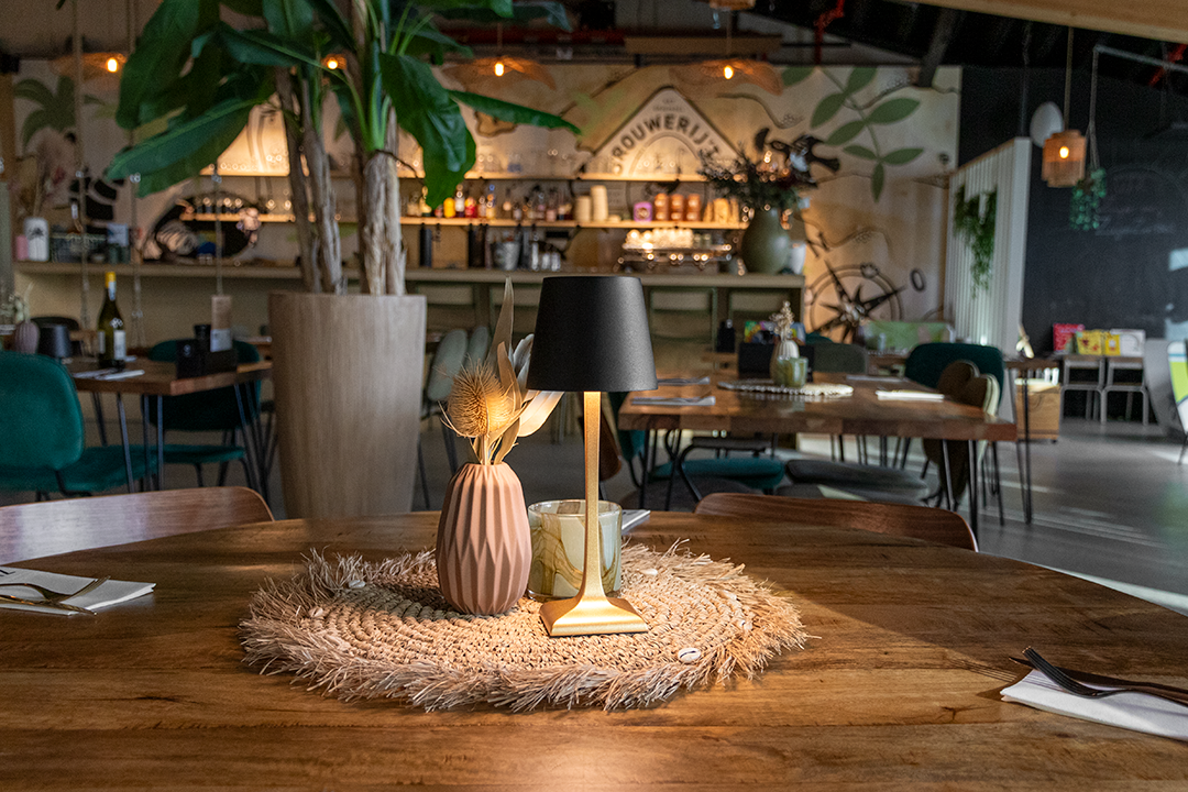 Labaro Rechargeable Table Lamp on a Wooden Table Inside a Restaurant Labaro Rechargeable Table Lamp in Black on a Wooden Table Inside a Restaurant, Table Lighting, Restaurant Lighting, Lighting for Table at Restaurant, Commercial Table Lighting, Hospitality Lighting, Rechargeable Table Lamps, LED Lighting, Outdoor Table Lamps, Indoor Table Lighting, Cafe Lighting, Table Lamps for Cafes