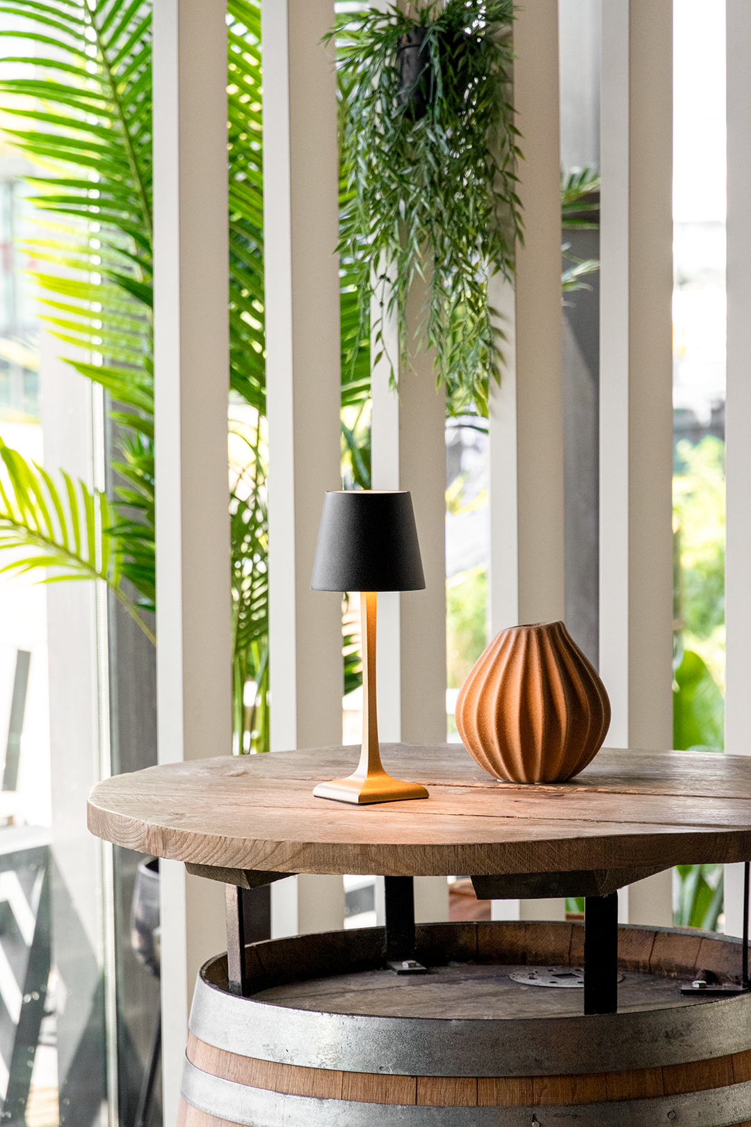 Labaro Rechargeable Table Lamp on a Wooden Table Outside a Restaurant Labaro Rechargeable Table Lamp in Black on a Wooden Table Outside a Restaurant, Table Lighting, Restaurant Lighting, Lighting for Table at Restaurant, Commercial Table Lighting, Hospitality Lighting, Rechargeable Table Lamps, LED Lighting, Outdoor Table Lamps, Indoor Table Lighting, Cafe Lighting, Table Lamps for Cafes