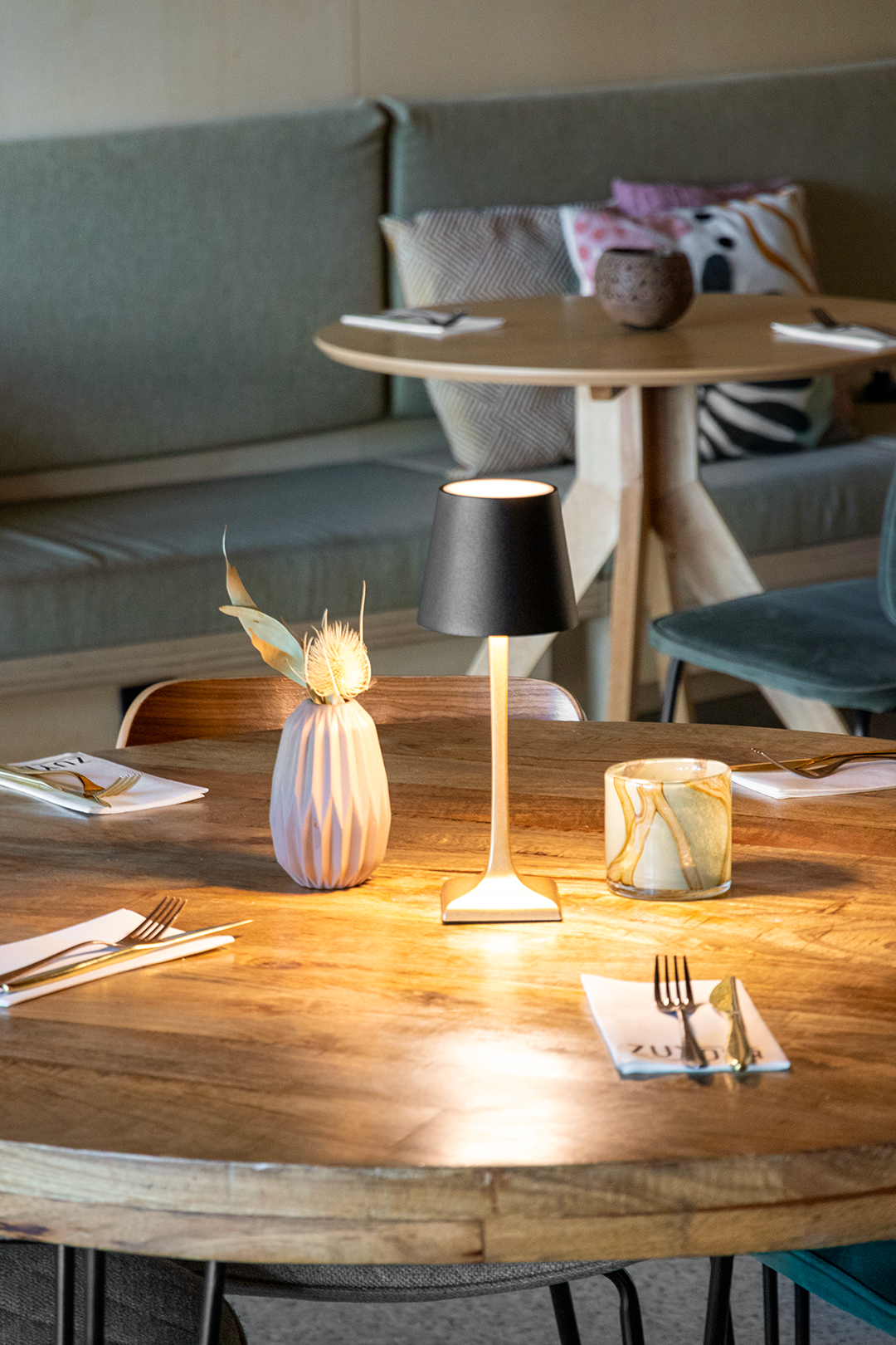 Labaro Rechargeable Table Lamp on a Wooden Table Inside a Restaurant Lit Up Labaro Rechargeable Table Lamp in Black on a Wooden Table Inside a Restaurant Lit Up, Table Lighting, Restaurant Lighting, Lighting for Table at Restaurant, Commercial Table Lighting, Hospitality Lighting, Rechargeable Table Lamps, LED Lighting, Outdoor Table Lamps, Indoor Table Lighting, Cafe Lighting, Table Lamps for Cafes