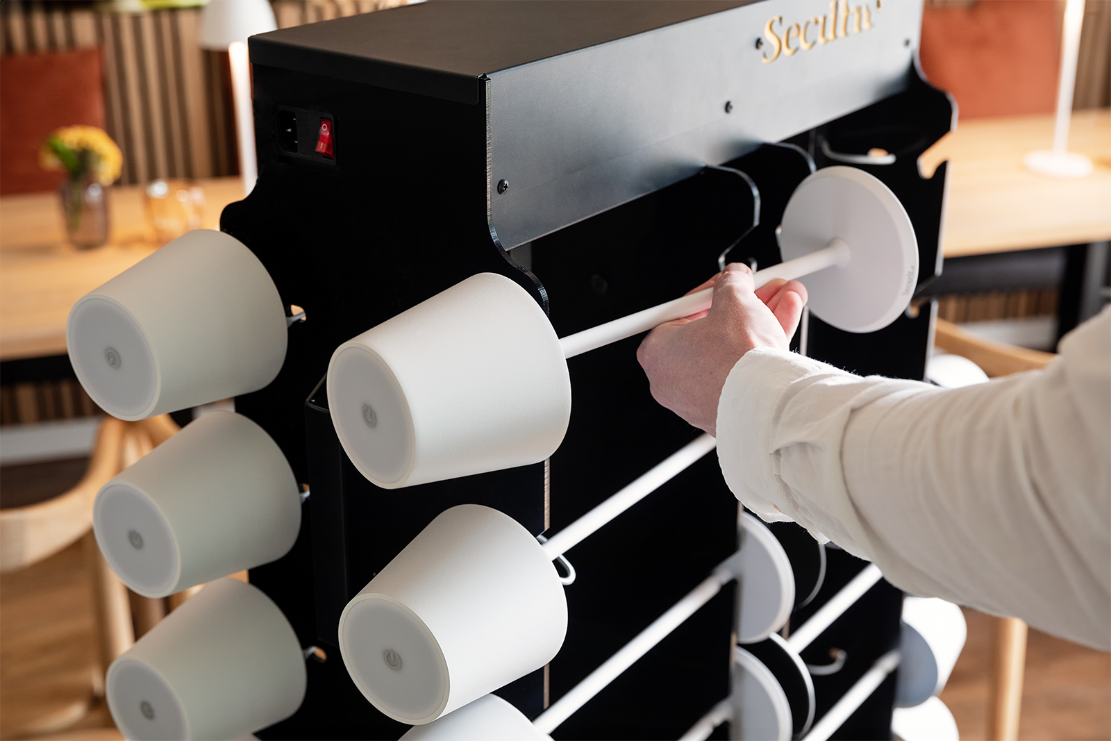 Waiter Charging Table Lamp at the Charging Trolley Inside a Restaurant Waiter Charging Table Lamp at the Charging Trolley Inside a Restaurant, Table Lighting Recharging Trolley, Charging Trolley, Lighting Charging Trolley
