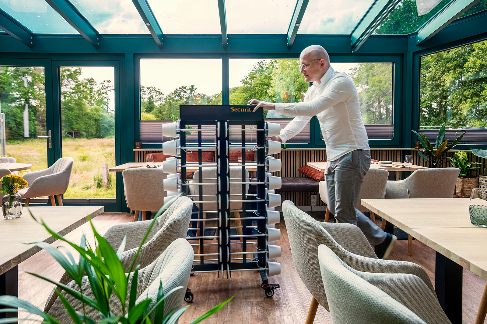 Waiter Putting out Lamps in a Restaurant from the Table Lamp Charging Trolley Waiter Putting out Lamps in a Restaurant from the Table Lamp Charging Trolley, Table Lighting Recharging Trolley, Charging Trolley, Lighting Charging Trolley