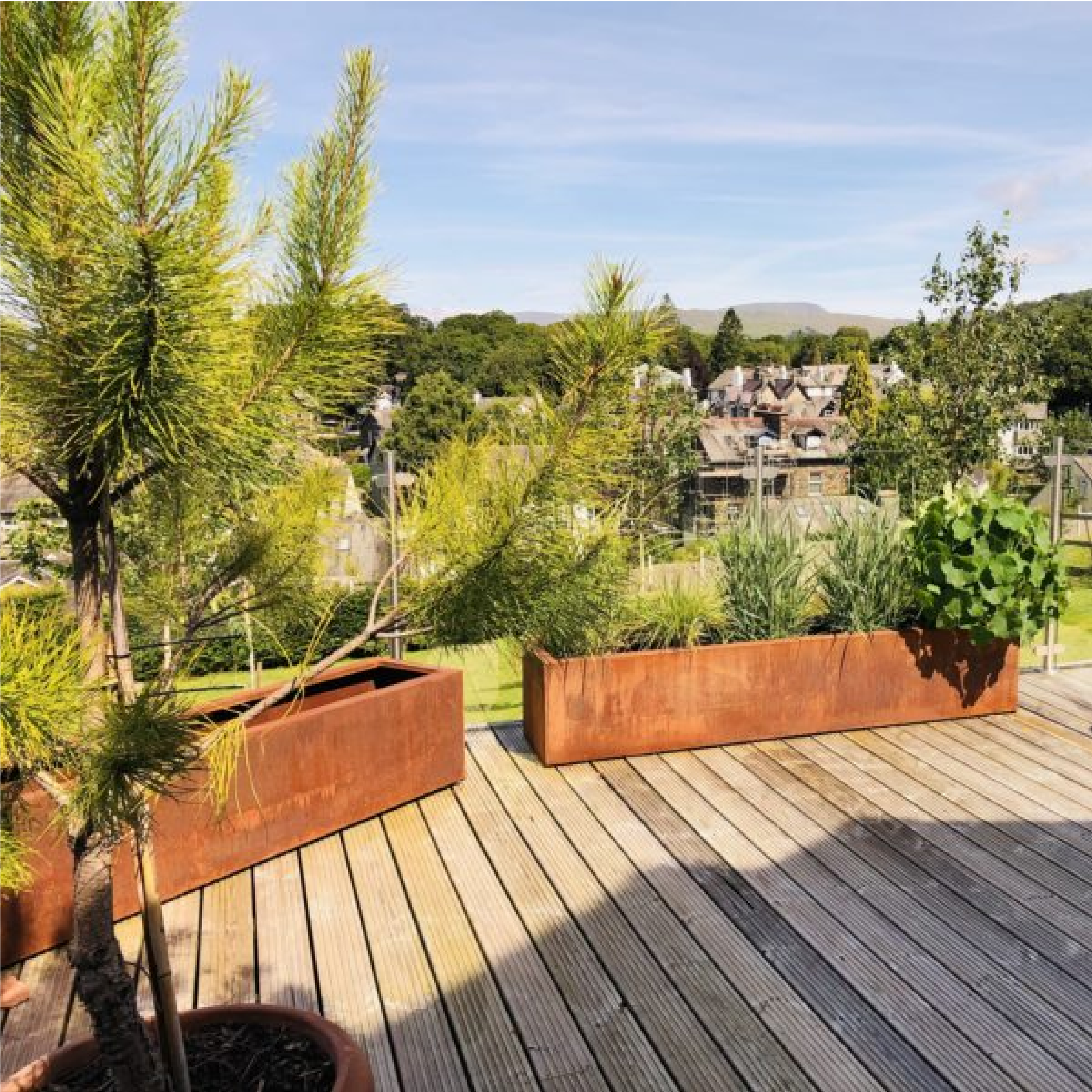Corten Steel Cafe Planter on decking Commercial Corten Metal Planter for Outdoor Use, Corten Steel Industrial Cafe Planter Trough with Plants, Restaurant Planters, Metal Cafe Planters, Commercial Planters, Bespoke Cafe Planters, Custom-Made Cafe Planters, planters for cafes, outdoor planters, alfresco planters