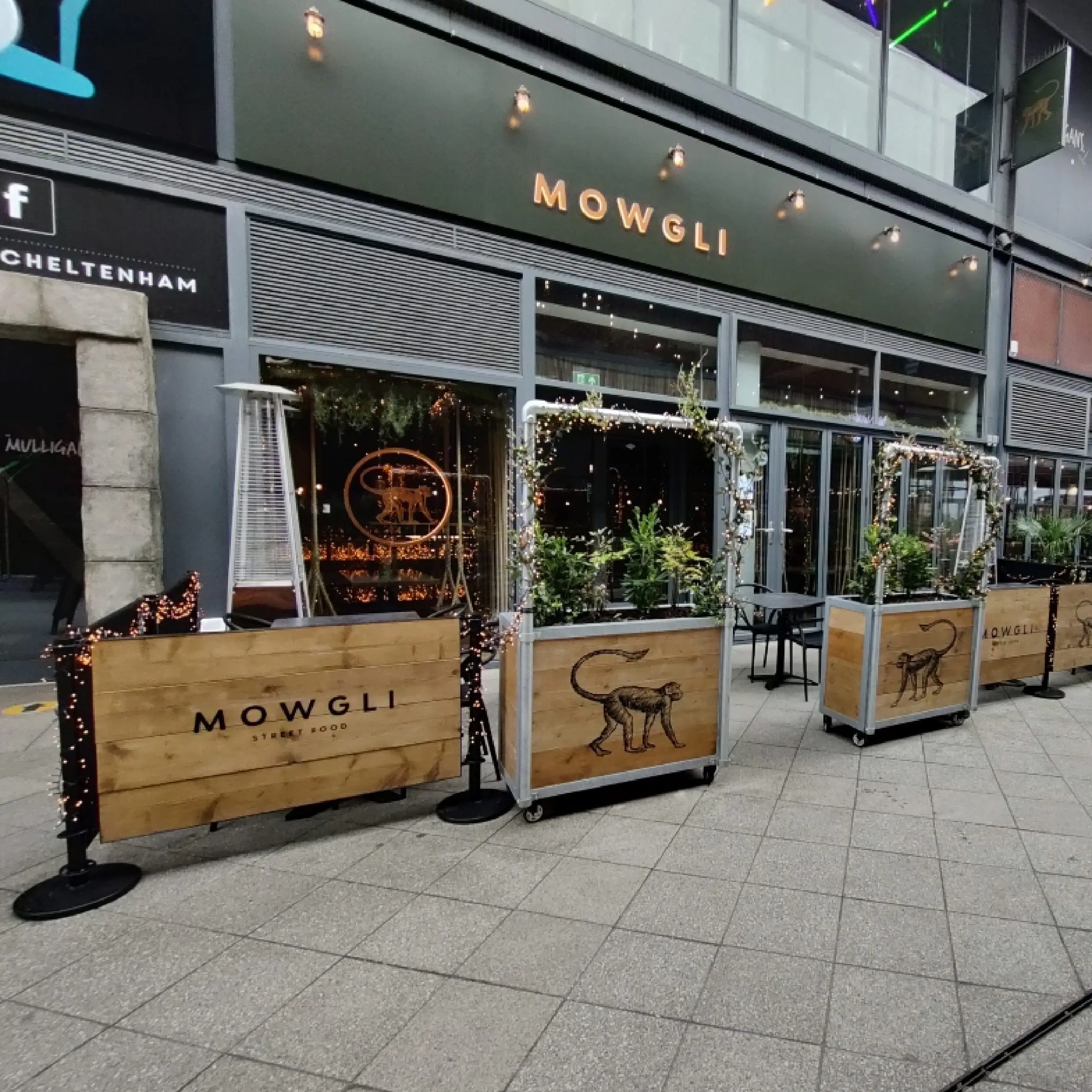 Mowgli 1 - Wooden Framed Cafe Panels Mowgli Gloucester - Cafe Barrier Posts with Wooden Framed Cafe Panels and Bespoke Wooden Cafe Planters with Mowgli Logo