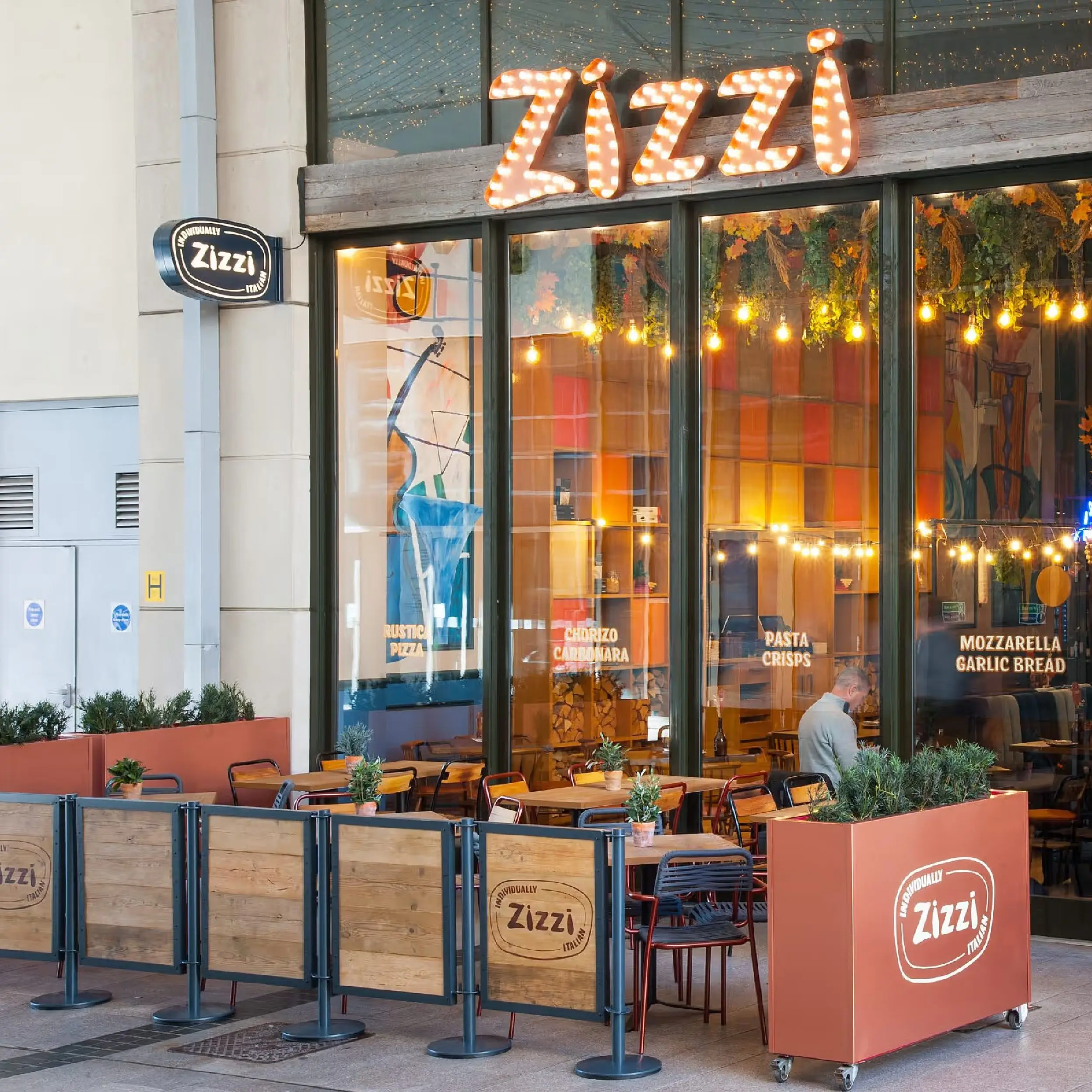 Zizzi High Wycombe - Wooden Framed Cafe Panels Zizzi High Wycombe Reclaimed Scaffold Board Wooden Framed Panels with Advance Posts in Anthracite Grey & Forjado Metal Cafe Planters